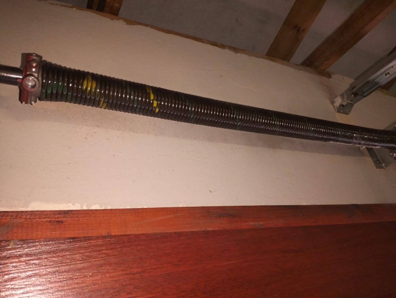 Close-up of a garage door torsion spring