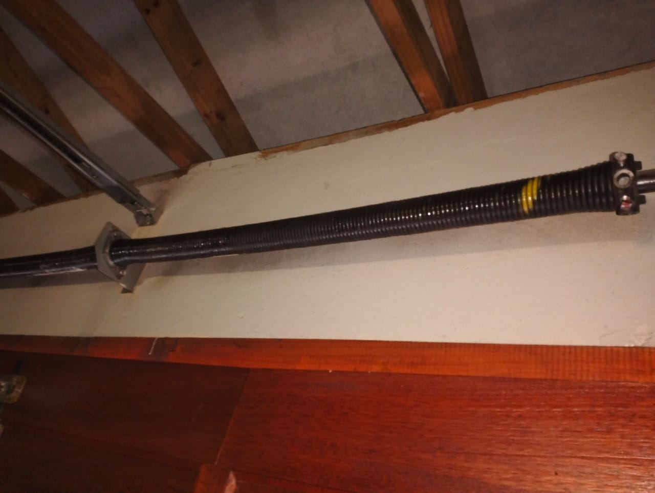 Full view of a garage door torsion spring assembly